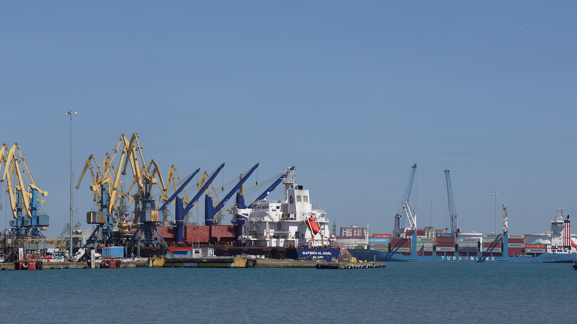 Urban harbour with cranes and city skyline